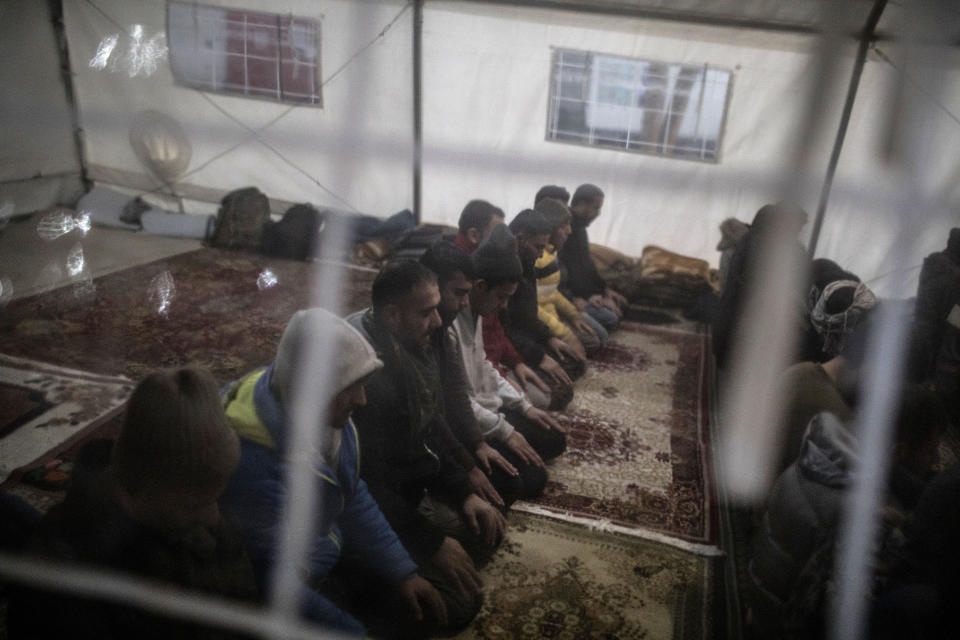 A group of migrants, mostly form Pakistan and Afghanistan pray at a makeshift mosque at temporary reception centre set up by the IOM (International Organization for Migrants) in Bihac, northwestern Bosnia on Dec. 12, 2019. (Photo: Manu Brabo/AP)