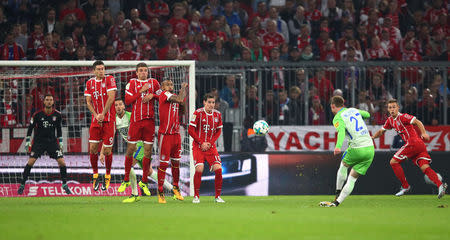 Soccer Football - Bundesliga - FC Bayern Munich vs VfL Wolfsburg - Allianz Arena, Munich, Germany - September 22, 2017 Wolfsburg's Maximilian Arnold scores their first goal from a free kick as Bayern Munich's Sven Ulreich (L) looks on REUTERS/Michael Dalder