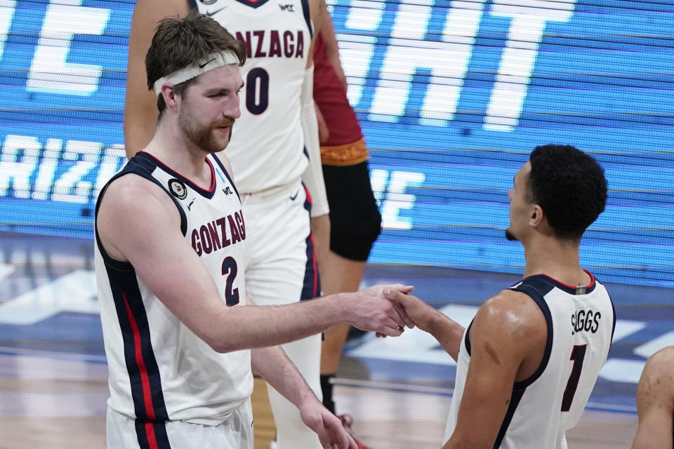 Gonzaga forward Drew Timme (2) celebrates with teammate Jalen Suggs (1) after an Elite 8 game against Southern California in the NCAA men's college basketball tournament at Lucas Oil Stadium, Tuesday, March 30, 2021, in Indianapolis. Gonzaga won 85-66. (AP Photo/Michael Conroy)