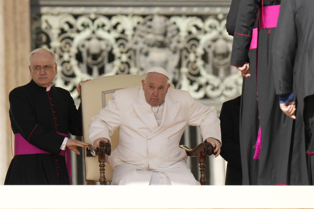 Pope Francis holds his weekly general audience with Monsignor Leonardo Sapienza, left, in St. Peter's Square, at the Vatican, Wednesday, March 29, 2023. (AP Photo/Alessandra Tarantino)