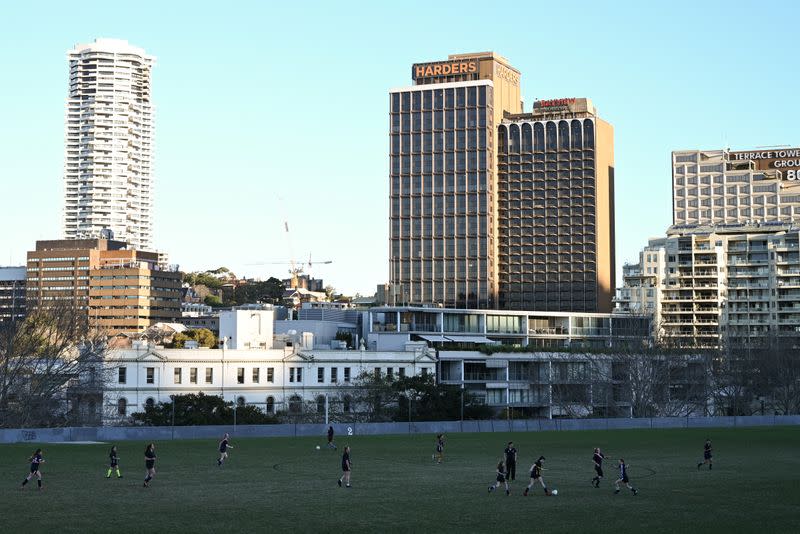 Youths play soccer at a park in the city centre in Sydney