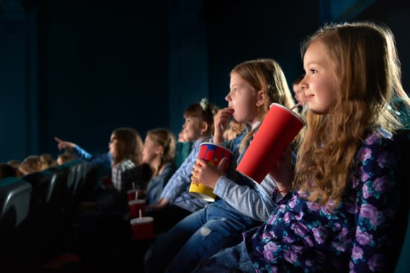 Kids watching a movie at a theater.