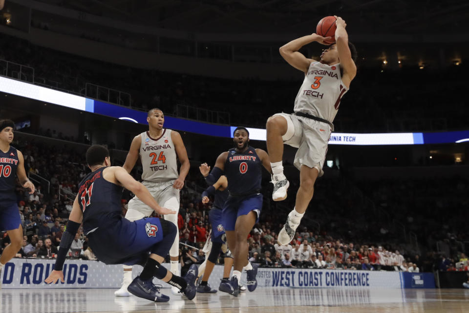 Virginia Tech guard Wabissa Bede, right, shoots over Liberty guard Georgie Pacheco-Ortiz during the second half of a second-round game in the NCAA men's college basketball tournament Sunday, March 24, 2019, in San Jose, Calif. (AP Photo/Jeff Chiu)