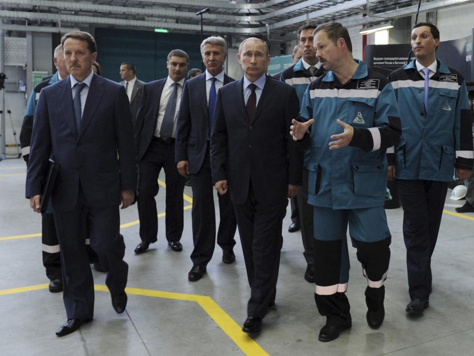 President Vladimir Putin at the center of a group of businessmen in "Voronezhsintezkauchuk" plant, part of the SIBUR company, in Voronezh. Kirill Shamalov walks to the far right.
