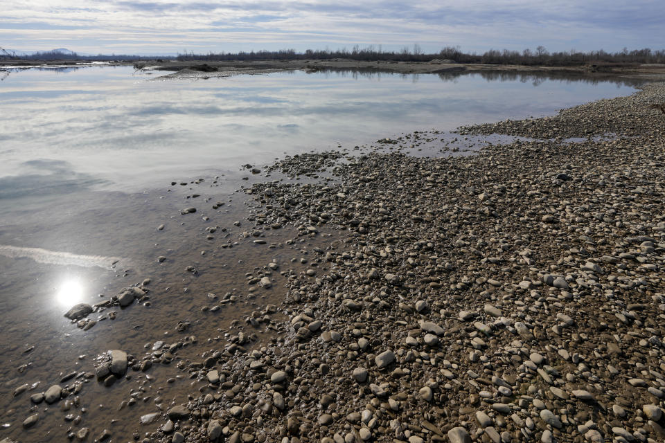 A view of the bank of the Drina River near the village of Amajlije, eastern Bosnia, Sunday, Feb. 4, 2024. In several cities along this river between Bosnia and Serbia, simple, durable gravestones now mark the final resting places of dozens of refugees and migrants who drowned in the area while trying to reach Western Europe.(AP Photo/Darko Vojinovic)