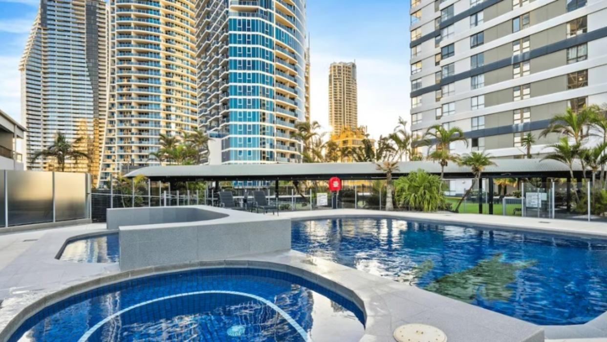 Two men were have drowned in a Surfers Paradise hotel pool after saving their relatives who could not swim.