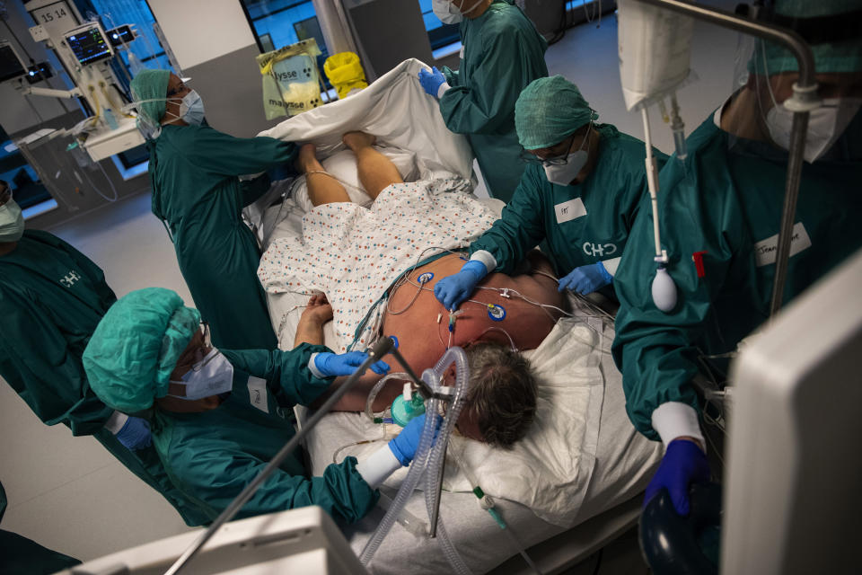 Medical personnel work in the intensive care ward for Covid-19 patients at the MontLegia CHC hospital in Liege, Belgium, Friday, Nov. 6, 2020. Coronavirus cases have surged around Europe in recent weeks, putting fresh pressure on overworked medical staff and hospitals, and forcing several countries to impose tough new movement restrictions. (AP Photo/Francisco Seco)