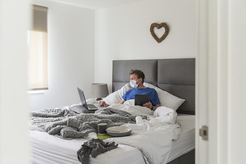 Man in self isolation in bed with the flu