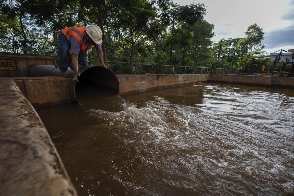 A mining engineer shows how they filter water at a chromium mine near Kaliapani village in Jajpur district, Odisha, India on July 5, 2023. Chromium, used mostly as a coating to stop rust in steel and car parts, has been deemed necessary for India's transition to cleaner energy. (AP Photo/Anupam Nath)