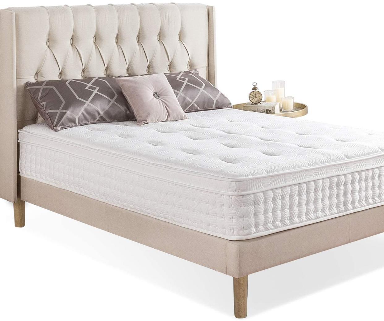 White mattress on cream bed frame.