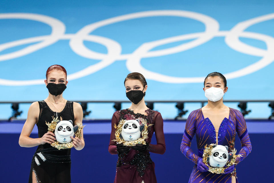 Silver medalist Alexandra Trusova of Team ROC, gold medal winner Anna Shcherbakova of Team ROC and bronze medalist Kaori Sakamoto of Japan are seen during the flower ceremony for the women's figure skating at the 2022 Winter Olympic Games.  / Credit: BEIJING, CHINA - FEBRUARY 17, 2022: Silver medallist Alexandra Trusova of Team ROC, gold medal winner Anna Shcherbakova of Team ROC and bronze medallist Kaori Sakamoto of Japan (L-R) are seen during the flower ceremony for the women's figure skating at th