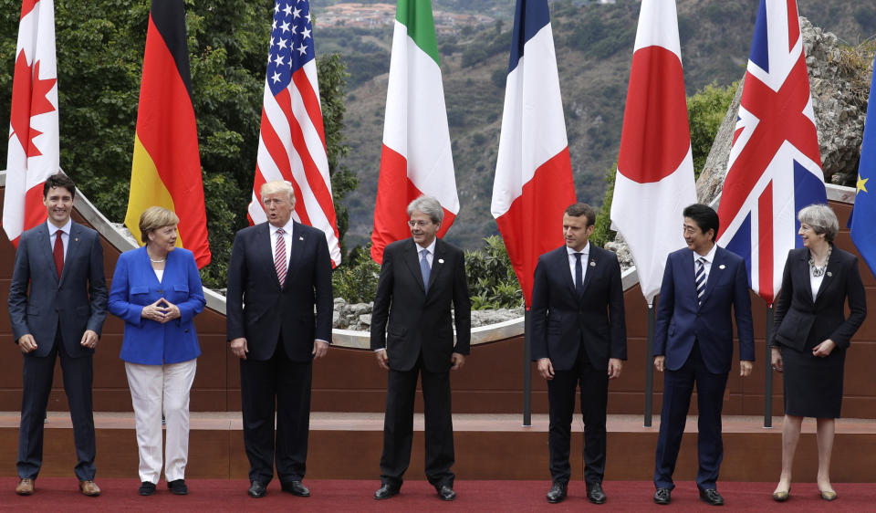 FILE - In this Friday, May 26, 2017 file photo, leaders of the G7, from left, Canadian Prime Minister Justin Trudeau, German Chancellor Angela Merkel, U.S. President Donald Trump, Italian Prime Minister Paolo Gentiloni, French President Emmanuel Macron, Japan's Prime Minister Shinzo Abe, and British Prime Minister Theresa May pose during a group photo for the G7 summit in the Ancient Theatre of Taormina in the Sicilian citadel of Taormina, Italy. Millions of women admire the 67-year-old for breaking through the glass ceiling of male dominance in politics, and she’s been lauded as an impressive role model for girls both at home and around the globe. (AP Photo/Andrew Medichini, File)