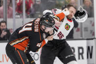 Chicago Blackhawks defenseman Jarred Tinordi, right, loses his helmet during an altercation with Anaheim Ducks left wing Ross Johnston during the first period of an NHL hockey game Thursday, March 21, 2024, in Anaheim, Calif. (AP Photo/Ryan Sun)