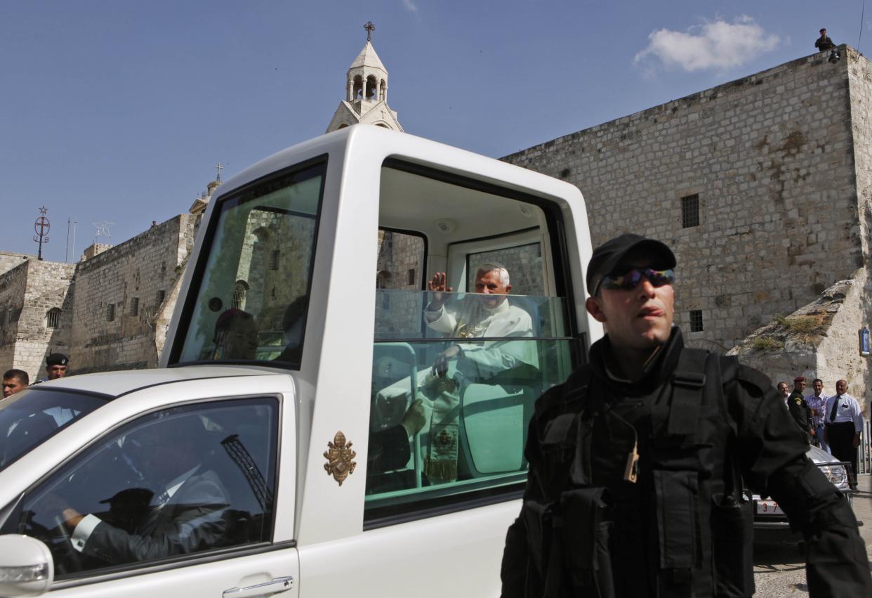 FILE - Pope Benedict XVI waves to journalists as he leaves the Church of the Nativity, traditionally believed to be the birthplace of Jesus Christ, in the West Bank town of Bethlehem on May 13, 2009. Pope Emeritus Benedict XVI, the German theologian who will be remembered as the first pope in 600 years to resign, has died, the Vatican announced Saturday. He was 95. (AP Photo/Kevin Frayer, File)