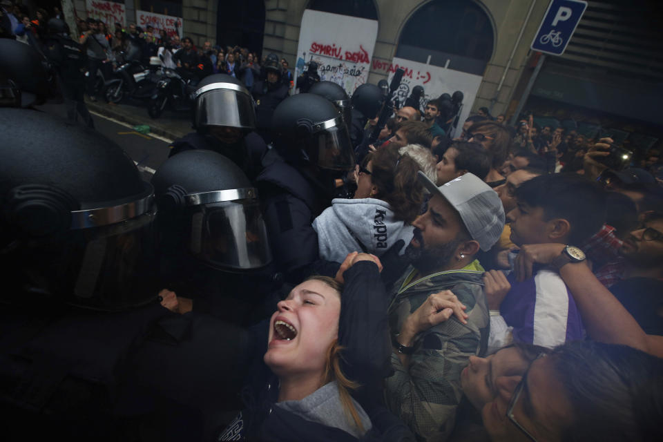 <p>A girls grimaces as Spanish National Police pushes away Pro-referendum supporters outside the Ramon Llull school assigned to be a polling station by the Catalan government in Barcelona, Spain, 1 Oct. 2017. (Photo: Emilio Morenatti/AP) </p>