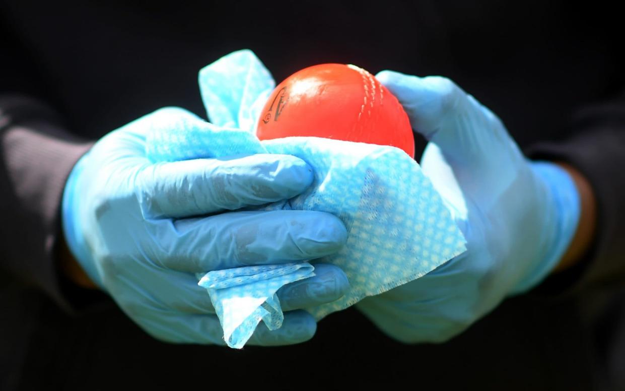 A coach wipes down junior cricket balls at Wimbledon Cricket Club, south-west London - Alex Davidson/Getty Images Europe