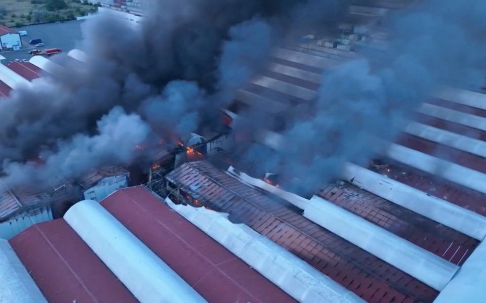 Smoke billows from a fire at a site of storage facilities hit during Russian strikes on Odesa