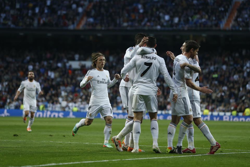Real's Cristiano Ronaldo, center, celebrates his goal with teammates during a Spanish La Liga soccer match between Real Madrid and Levante at the Santiago Bernabeu stadium in Madrid, Spain, Sunday March 9, 2014. (AP Photo/Andres Kudacki)