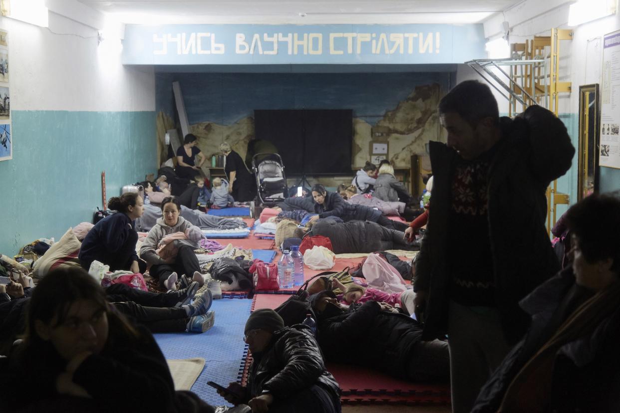 Hundreds of residents from a residential building damaged by a missile gather in a bomb shelter in the basement of a school on Feb. 25, 2022, in Kyiv, Ukraine.