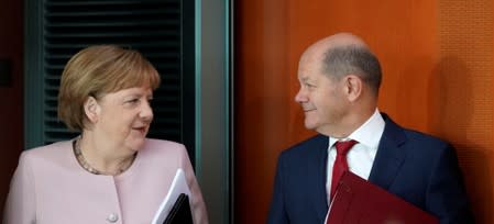 FILE PHOTO: German Chancellor Angela Merkel and Finance Minister Olaf Scholz attend the cabinet meeting in Berlin