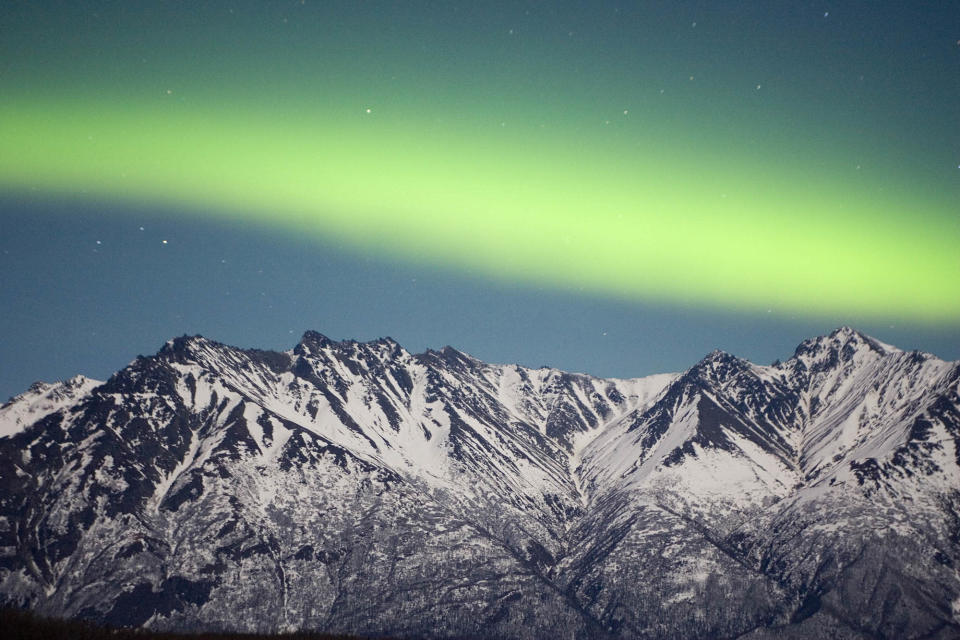 A band of Aurora Borealis, the Northern Lights, stretches over the Chugach Range near Palmer, Alaska in this February file photo. Scientists think they have discovered the energy source of the spectacular color displays seen in the northern lights. (AP Photo/Bob Martinson, FILE)