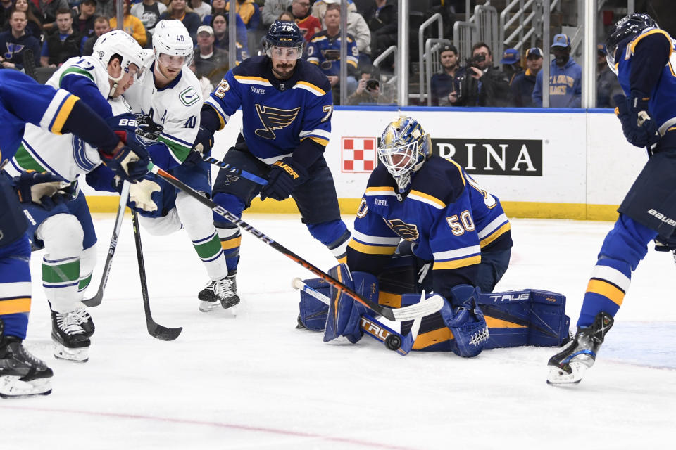 St. Louis Blues goaltender Jordan Binnington (50) defends the net against the Vancouver Canucks during the first period of an NHL hockey game Thursday, Feb. 23, 2023, in St. Louis. (AP Photo/Jeff Le)