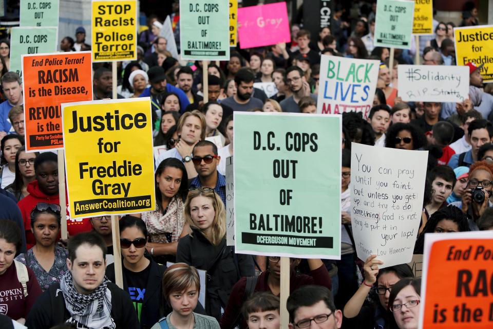 Protesters against police violence stop traffic at a major intersection in the Chinatown neighborhood as they begin a march towards the White House in Washington