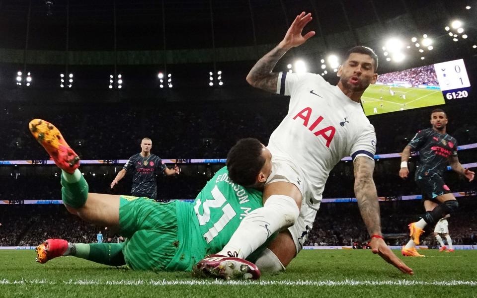 Cristian Romero of Tottenham Hotspur collides with Ederson of Manchester City