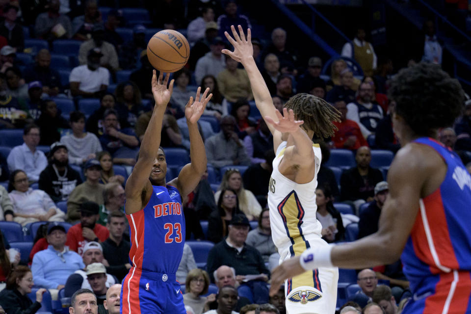 Detroit Pistons guard Jaden Ivey (23) shoots against New Orleans Pelicans guard Dyson Daniels during the first half of an NBA basketball game in New Orleans, Thursday, Nov. 2, 2023. (AP Photo/Matthew Hinton)