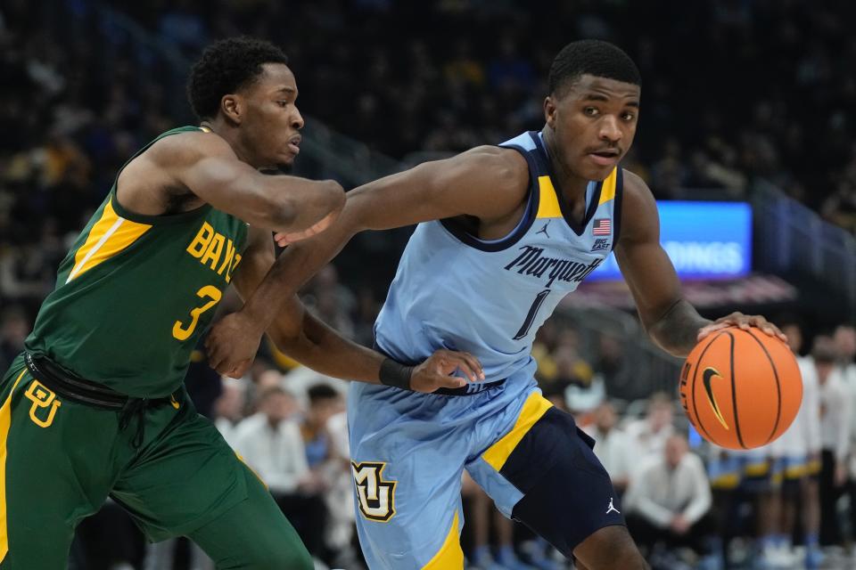 Marquette's Kam Jones drives past Baylor's Dale Bonner during the first half of an NCAA basketball game Tuesday, Nov. 29, 2022, in Milwaukee. (AP Photo/Morry Gash)
