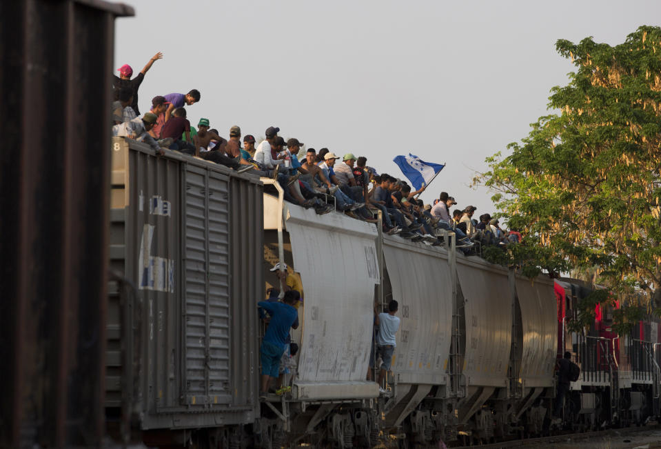 FILE - In this April 23, 2019, file photo, Central American migrants ride atop a freight train during their journey toward the U.S.-Mexico border, in Ixtepec, Oaxaca State, Mexico. Five American journalists brought a lawsuit Wednesday, Nov. 20, 2019, against the U.S. government that alleges border authorities violated their First Amendment rights by inspecting their cameras and notebooks and questioning them extensively about their coverage of last year's migrant caravan. The lawsuit seeks to test the limits of broad authority that U.S. officials have to question anyone, including journalists, who arrive by land, air or sea. (AP Photo/Moises Castillo, File)