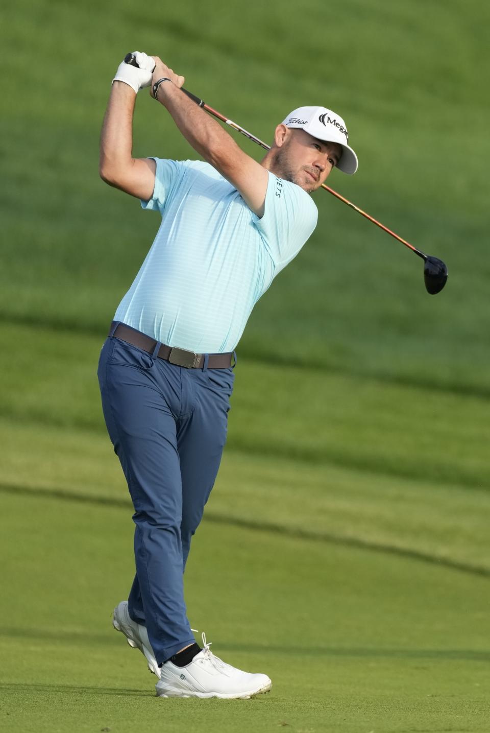 Brian Harman of the U.S. plays his second shot on 10th hole during the first round of the Hero Dubai Desert Classic golf tournament, in Dubai, United Arab Emirates, Thursday, Jan. 18, 2024. (AP Photo/Kamran Jebreili)