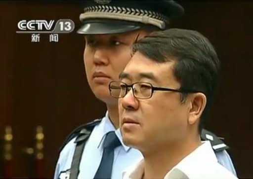 This frame grab, taken from Chinese television CCTV on September 18, shows former police chief Wang Lijun (R) facing the court during his trial in Chengdu, in southwest China's Sichuan province. Judgement in the case of Wang, who was tried for defection and other offences in a scandal that brought down top politician Bo Xilai, will be given on Monday, a court official told AFP