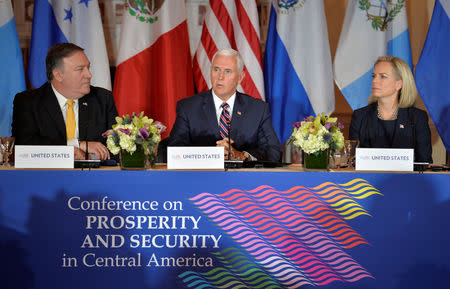 Vice President Mike Pence (C) makes opening remarks as U.S. Secretary of State Mike Pompeo (L) and Dept. of Homeland Security Secretary Kirstjen Nielsen listens during the Second Conference on Prosperity and Security in Central America, which includes Mexico, Guatemala, Honduras and El Salvador, at the State Department, in Washington, U.S., October 11, 2018. REUTERS/Mike Theiler