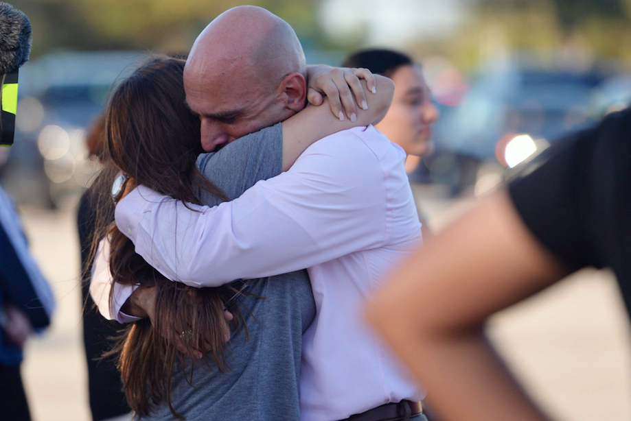 <em>Emotional parents were reunited with their children after a gunman killed 17 people in the Florida school (Rex)</em>
