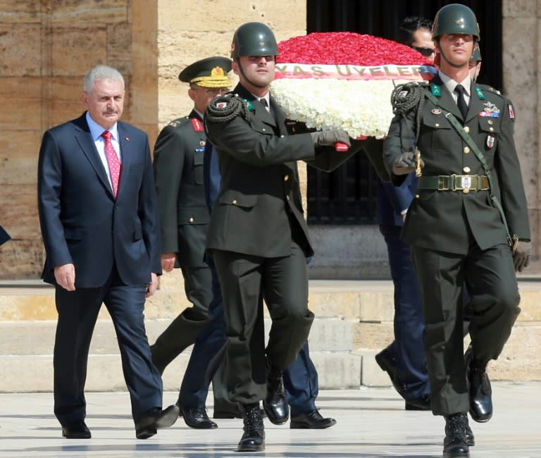 Turkey's Prime Minister Binali Yildirim (L) and members of Turkish Supreme Military Council (YAS) are seen during their visit at Anitkabir, mausoleum of Mustafa Kemal Ataturk in Ankara, on July 28, 2016