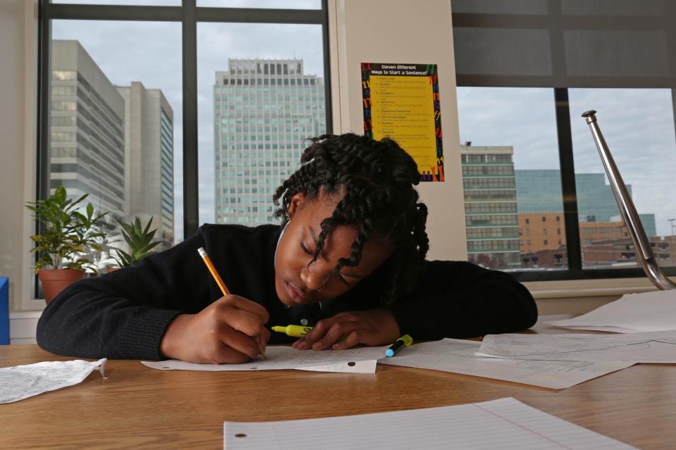 Taliyah Duval, 11, a sixth-grader at Kuumba Academy in the Community Education Building in Wilmington, writes a story about Greek mythology in 2014.