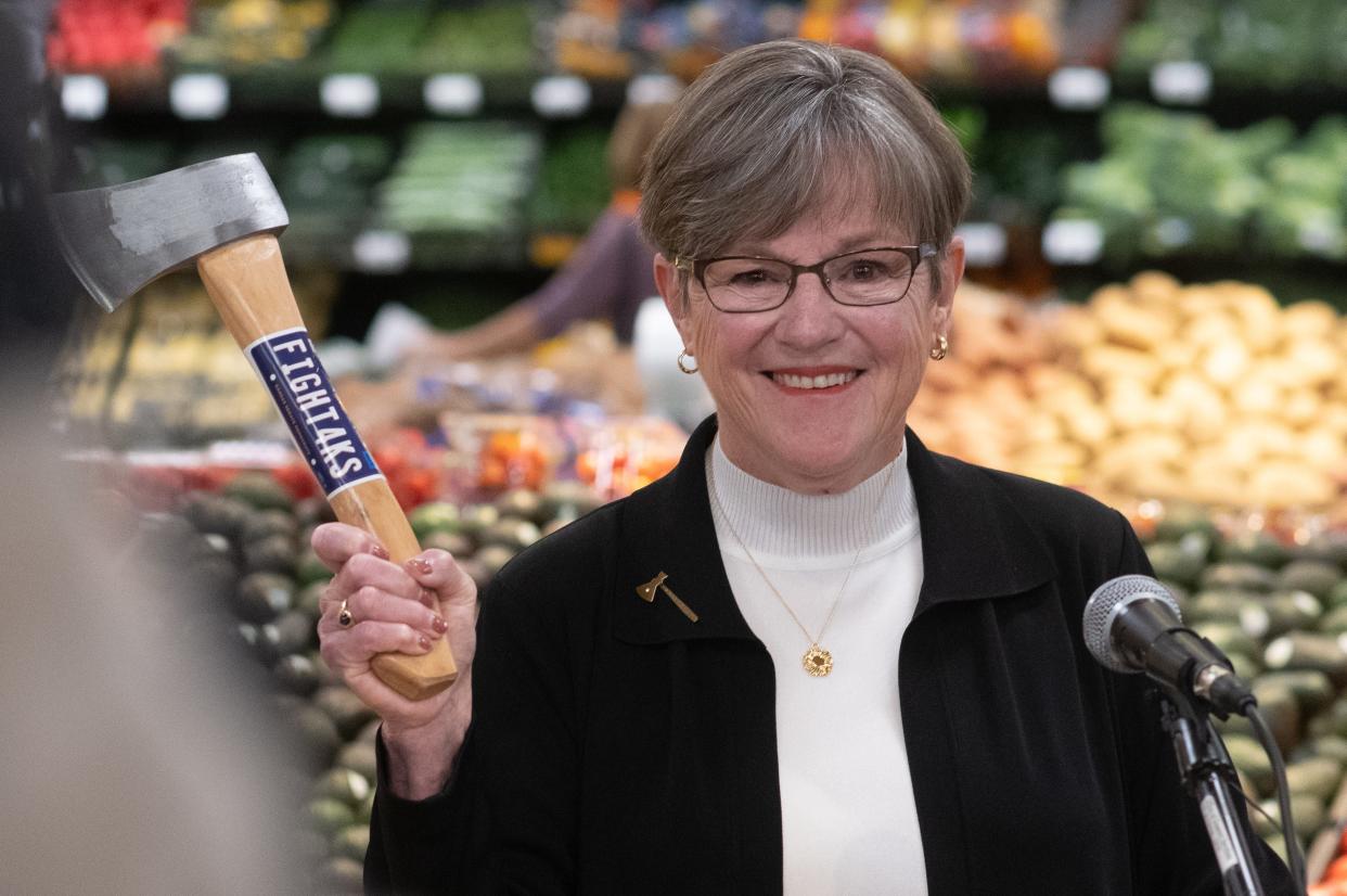 Wielding an axe, Gov. Laura Kelly announces her "axe the food tax" campaign at Dillons grocery store, 800 N.W. 25th St., on Monday afternoon. Kelly plans to introduce a bill for the coming legislative session that would eliminate the state's 6.5% sales tax on food.