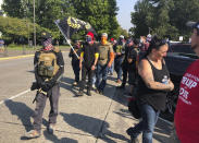 FILE - Members of the extremist right-wing group the Proud Boys arrive in Salem, Ore., on Monday Sept. 7, 2020 for a pro-Donald Trump rally at the Capitol. President Trump on Tuesday, Sept. 29, 2020 didn’t condemn white supremacist groups and their role in violence in some American cities this summer, branding it solely a “left-wing” problem and telling one far-right extremist group to “stand back and stand by.” (AP Photo/Andrew Selsky)