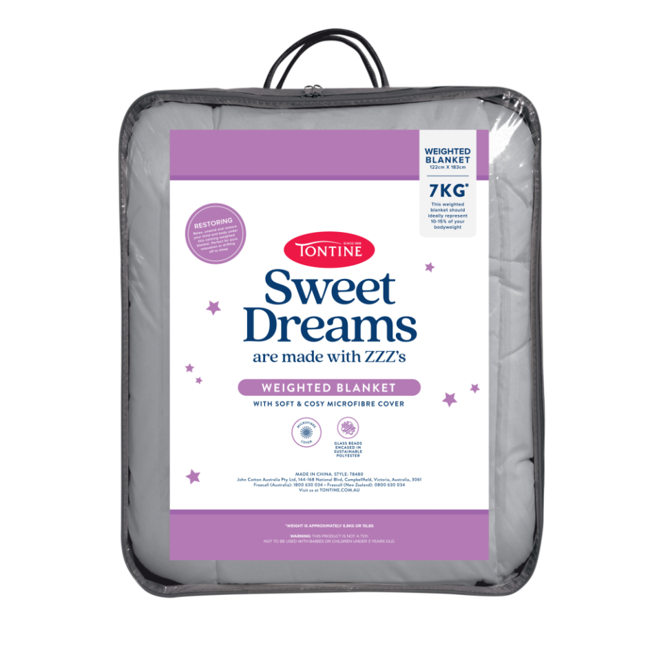 Tontine Sweet Dreams Microfibre Weighted Blanket, $75, shown in its clear packaging carry bag with white, red, blue and purple labelling.