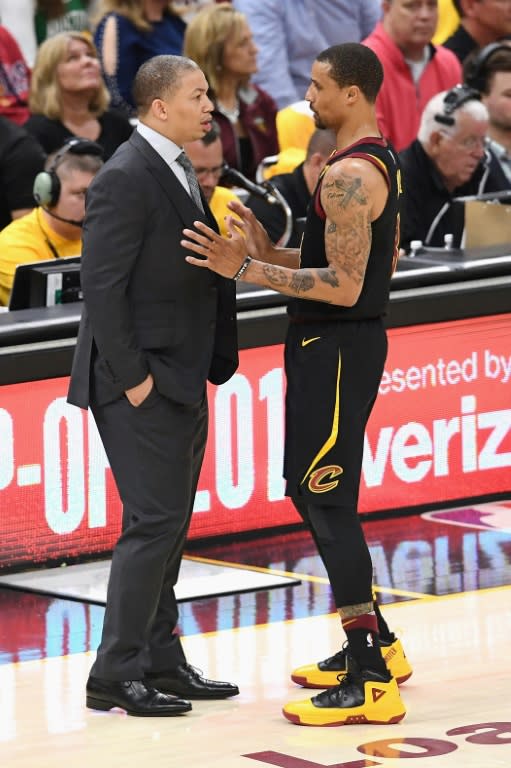 Head coach Tyronn Lue of the Cleveland Cavaliers talks with George Hill during game three against the Boston Celtics