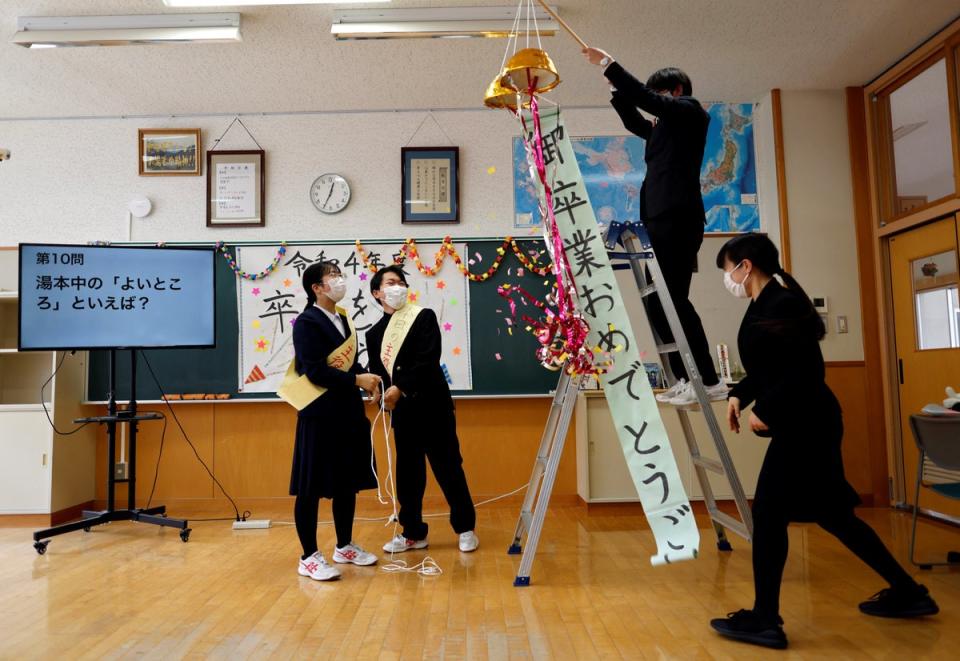 The last two students and their teachers attend a celebratory class before graduation (Reuters)