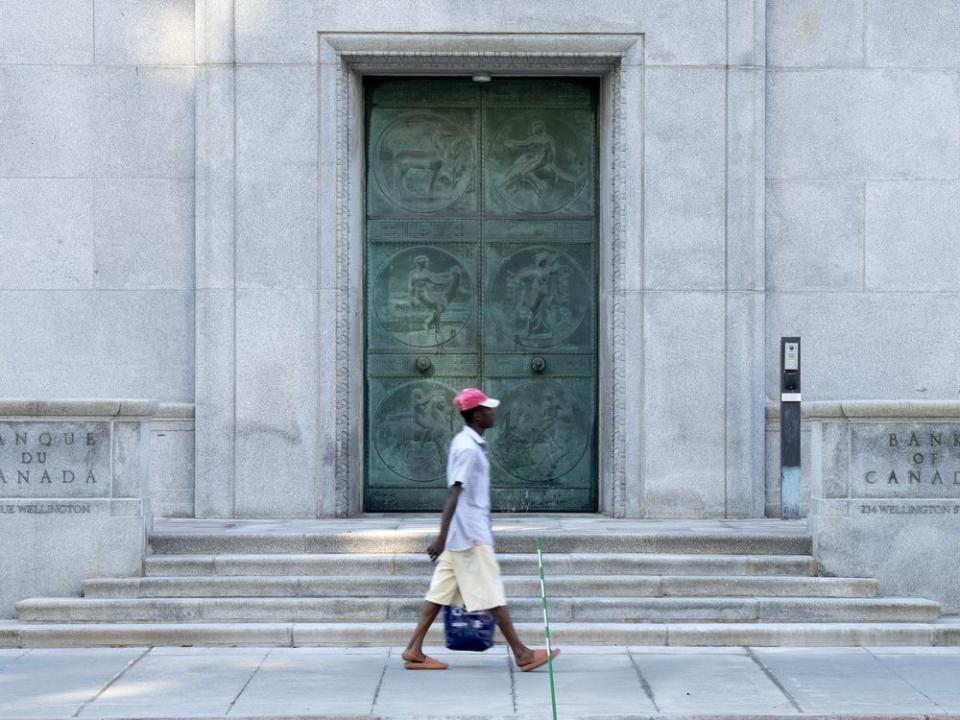  A pedestrian passes the Bank of Canada building in Ottawa.