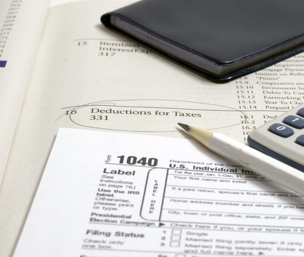 a 1040 tax form, a pen and a calculator