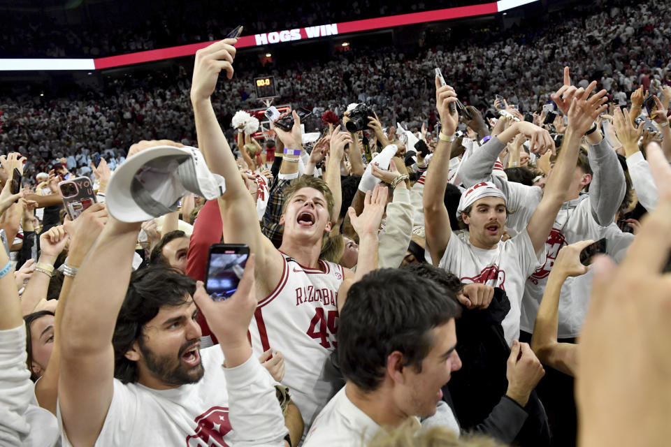 Arkansas' Lawson Blake (45) celebrates with fans after defeating Duke in an NCAA college basketball game Wednesday, Nov. 29, 2023, in Fayetteville, Ark. (AP Photo/Michael Woods)