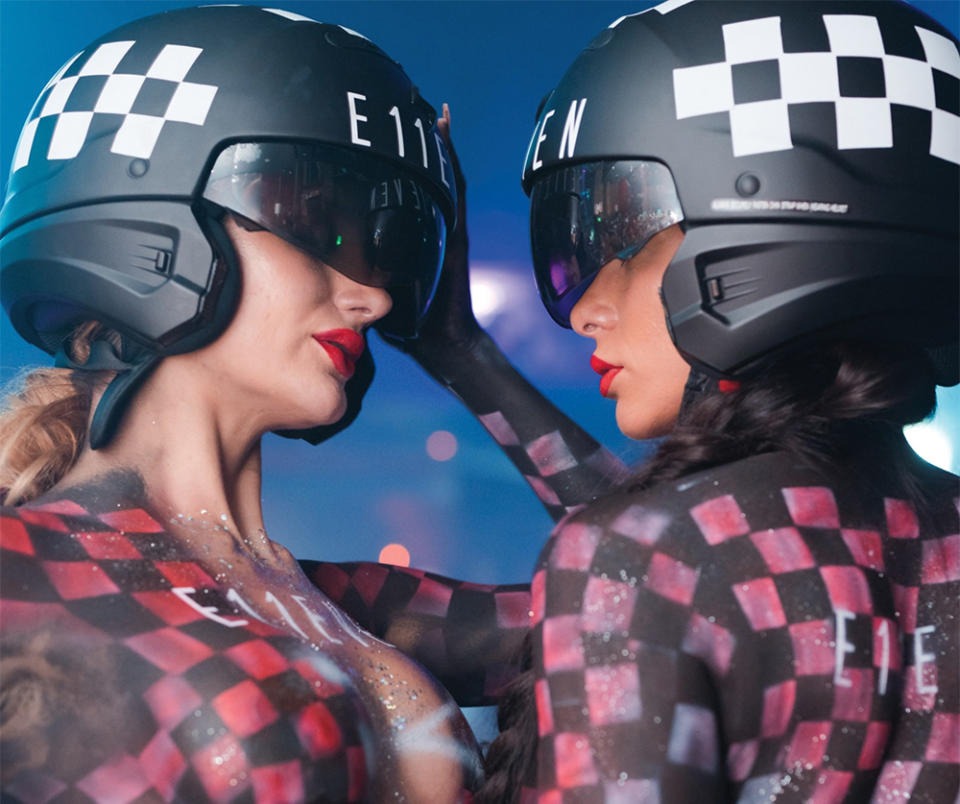 Two dancers in body-painted F1-style driver uniforms