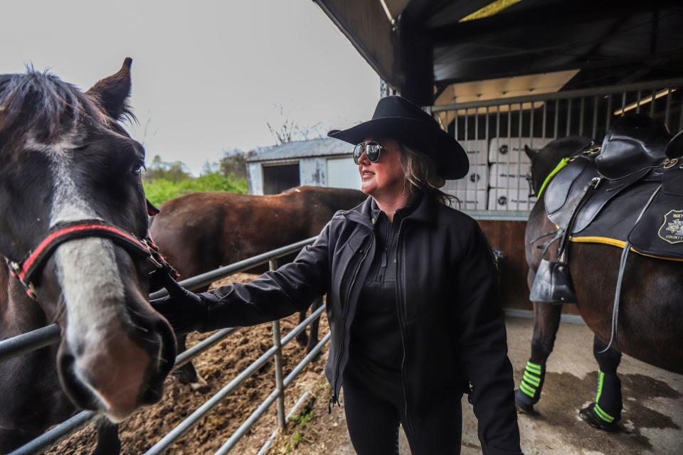 Sgt. Lacey Polderdyke prepares her horse, Hogan, to cover security during the NFL draft and NFL Draft Experience at the Wayne County Sheriff’s mounted division in Livonia, Mich., on Wednesday, April 24, 2024.