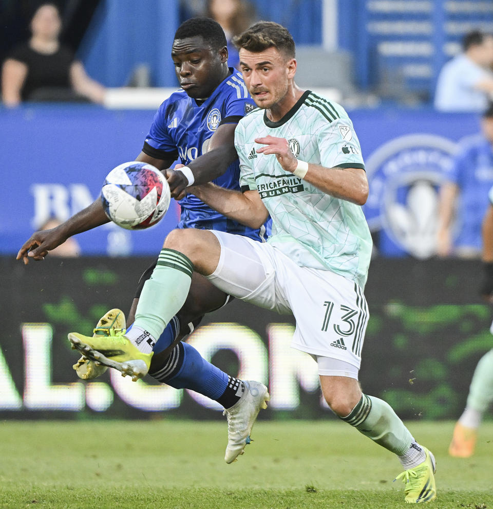 CF Montreal's Sunusi Ibrahim, left, defends against Atlanta United's Amar Sejdic (13) during the first half of an MLS soccer match Saturday, July 8, 2023, in Montreal. (Graham Hughes/The Canadian Press via AP)