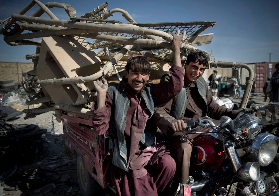 Afghan scrap collectors transport a load of destroyed U.S. equipment in Kandahar, Afghanistan.