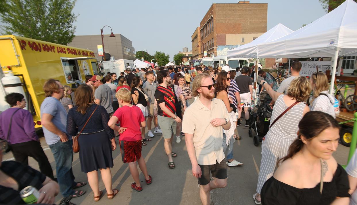 People stroll through the Ames Main Street Farmers' Market in May. The market is held in downtown Ames every Saturday from 8 a.m. to 12:30 p.m. during the summer.